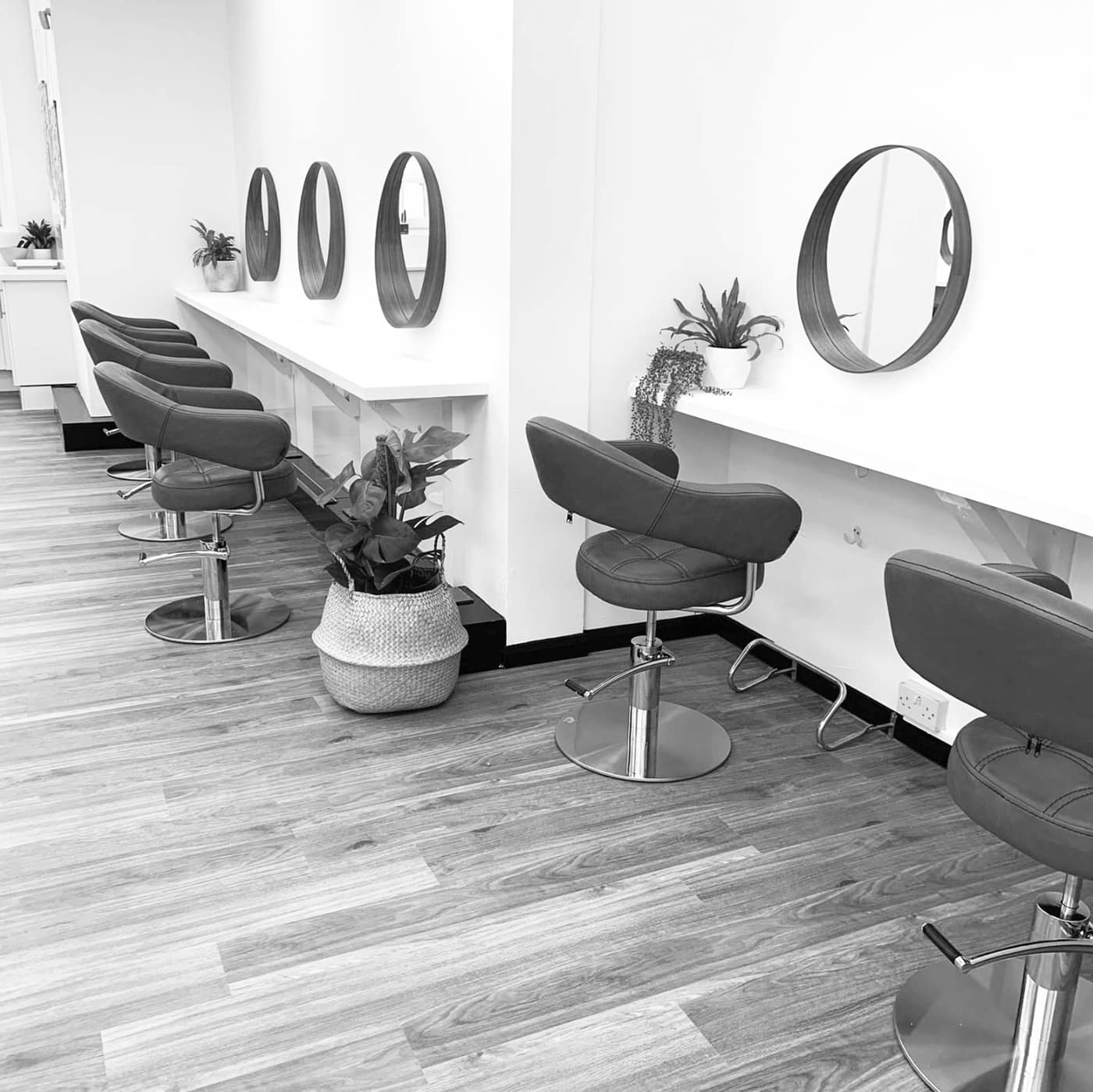 Inside Therapy Hair Body Nails in Canterbury — the styling chairs and round mirrors