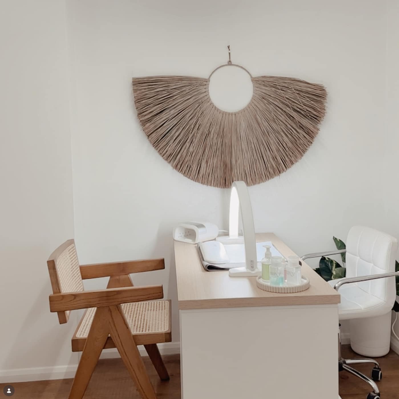 A nail desk with a lamp and two chairs inside the Therapy salon in Canterbury
