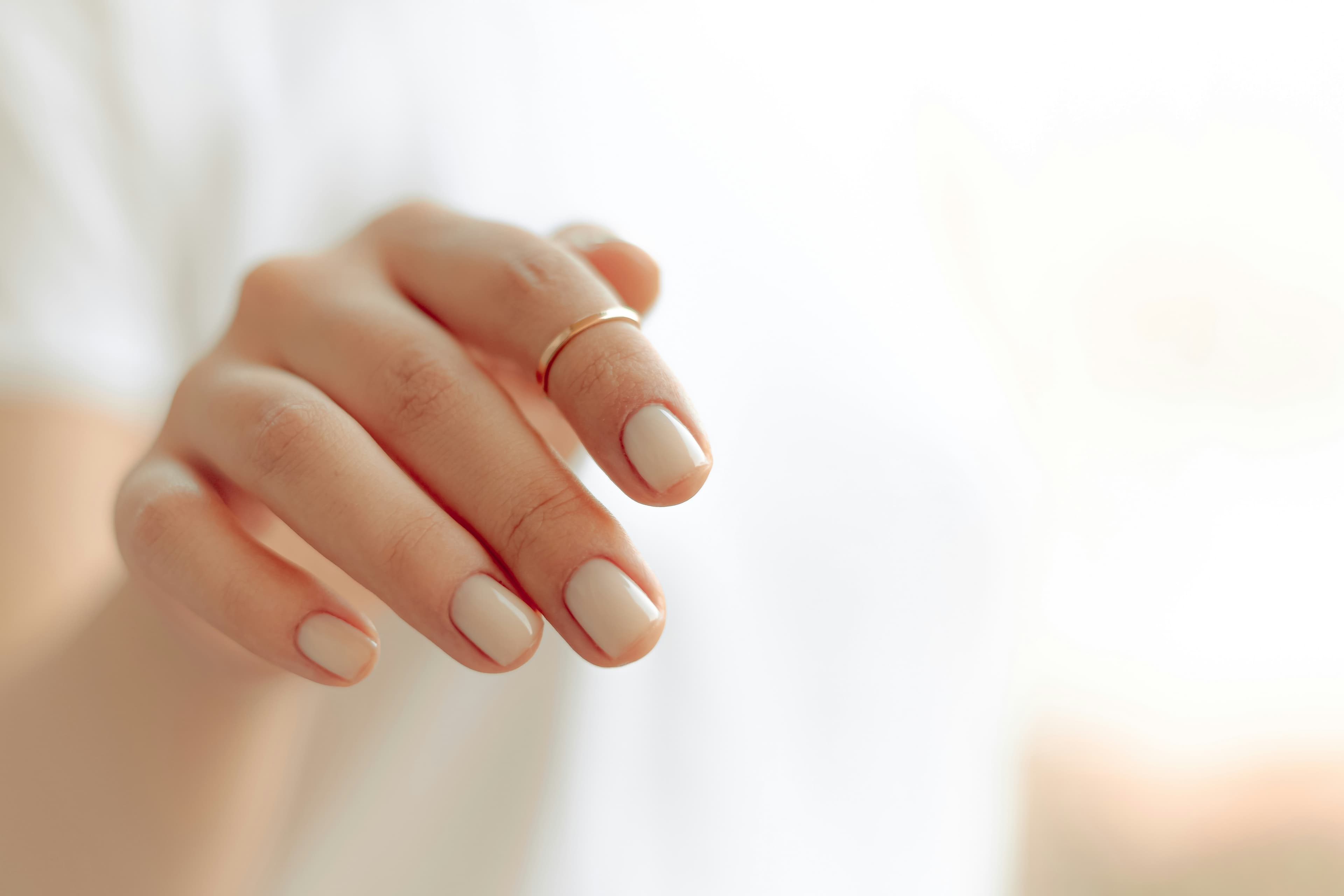 well manicured hands with a ring on one finger
